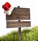 Weathered wooden sign with santa hat on white 