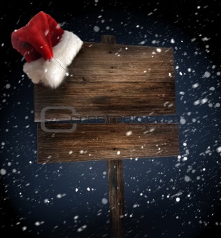 Weathered wooden sign with Santa hat