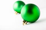 Green Christmas baubles on white