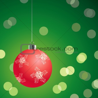 Red christmas ball on the green background