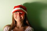 young girl with Santa's red cap.Look away