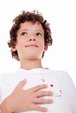cute boy showing an ace of hearts, in place of the heart, isolated on white, studio shot