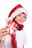 Cute christmas boy with a red gift isolated on white background, studio shot.