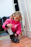 Little girl tying her shoes
