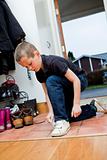 Little Boy tying his shoes