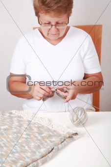 Elderly woman knitting
