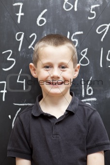 Young Boy in front of the blackboard