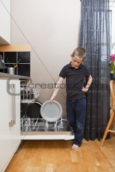 Young Boy by the Dishwasher