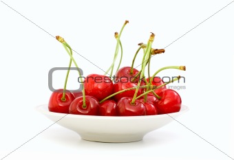 Saucer filled with red cherries