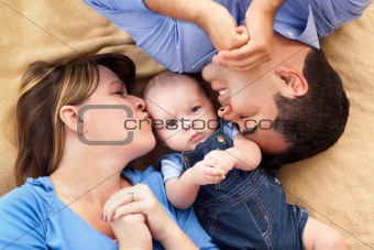 Mixed Race Family Playing Face Up on the Blanket.