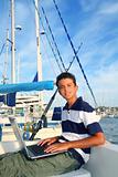 teenager on boat with laptop 