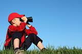 Boy looks into binoculars