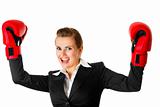 winning modern business woman wearing boxing gloves
