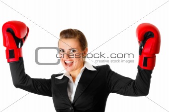 winning modern business woman wearing boxing gloves

