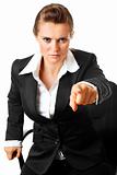 stressful modern business woman sitting on chair and pointing finger at you
