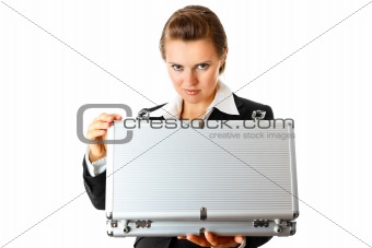 serious modern business woman holding open suitcase in hands
