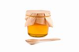 Honey in jar, spoon, isolated white background.