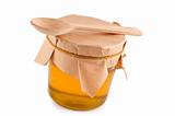 Honey in jar, wooden spoon, close up, isolated.