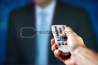 Male hand holding a remote control