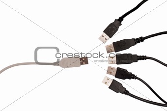 Grey usb cable facing five black usb cables