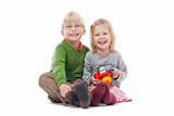 portrait of two young siblings looking at camera, smiling - isolated on white