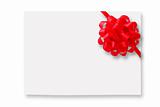 Blank gift tag tied with a bow of red satin ribbon.