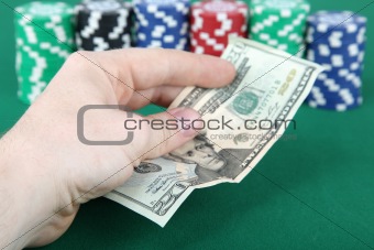 Twenty dollar bill and casino chips