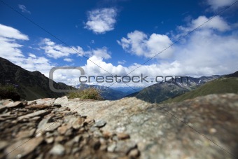 Mountain top under the blue sky with clouds