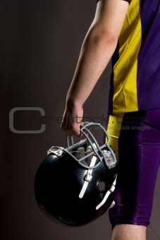 Athlete holding football helmet