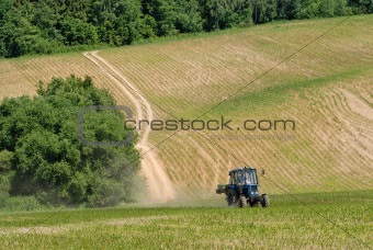 Tractor in a field in early summer