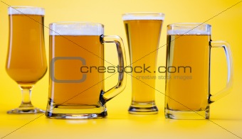 Beer glass with yellow background