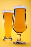 Beer glass with yellow background