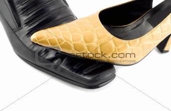 Black male shoe and yellow female shoe isolated on white
