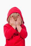little girl with blond hair covering her face with hands - isolated on white