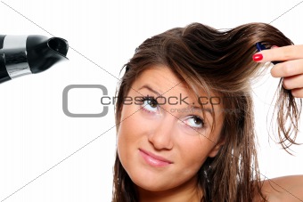 Young woman trying to brush her hair