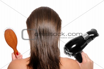 Young woman with a hair dryer and hairbrush