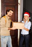 Man Receive a Box from Young Woman with Christmas Hat