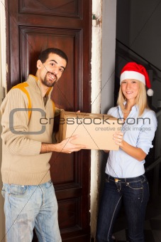 Man Receive a Box from Young Woman with Christmas Hat