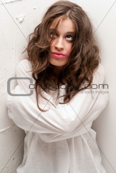 Young insane woman with straitjacket looking up camera close-up portrait