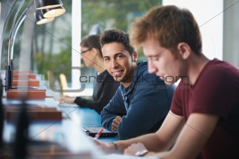 group of three people in library