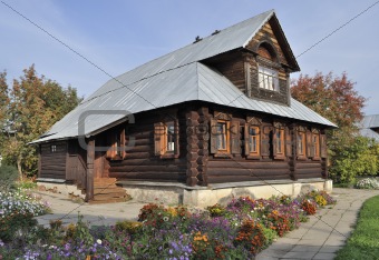 Beautiful wooden house with flowers, autumn