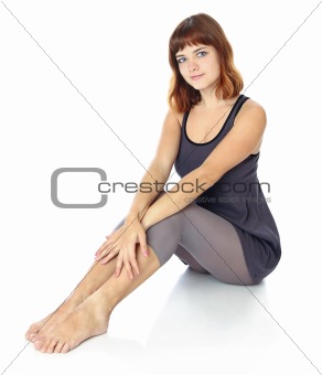 girl is sitting on the floor.