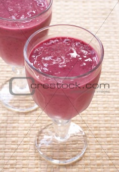 Two glasses of fresh berry smoothies