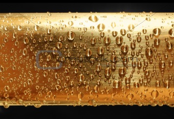 water drops on golden metal