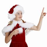 Surprised smiling girl in Christmas clothes points a finger