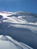 Powder snow and ski trails with blue skies