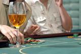 glass of wine on the table to play casino