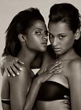 Two young ethnic sexy women in lingerie hugging