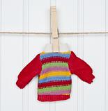 Warm Winter Striped Sweater on a Clothesline