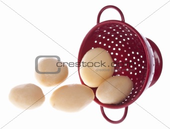 Red Colander Full of Canned New Potatoes